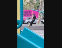 Policeman spin and plays at park playground