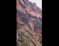 Two ladies on stairs lead to waterfall 