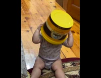 Baby angry when head covered with bucket
