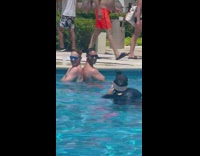 Two shirtless men crossed arms back to back