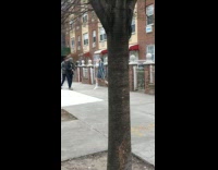 Guy and two girls dance outside apartment
