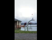 Guy red hoodie shoots ball from behind