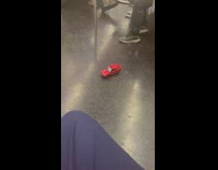 Red car with controller inside the train with passenger