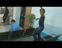 man in black sneaks up slaps man in blue