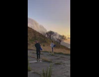 girl does yoga pose near mountain
