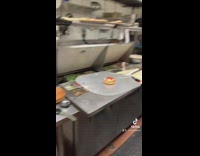 Guy pulls out tiny pizza bagel from oven 