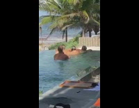 Three girls float on stomachs pool resort 