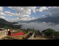 Clouds roll through mountain range time lapse