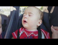 Slow motion baby boy on trolley sneeze