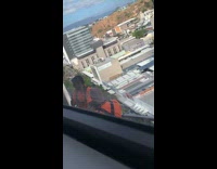 Man hammers outside the window while man films