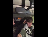 Girl in car hits boyfriend with purse 