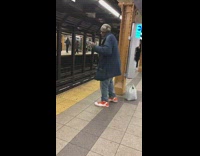 Old man dances to marimba music in subway station