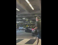 Man beside parked black car prayer pose