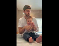 Man Plays with Baby as he Changes Diaper