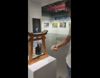 Boy hits and ring the bell inside the museum