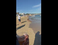 Lady poses with plate of food on beach