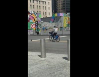 Guy pretends to ride blue rental bicycle 
