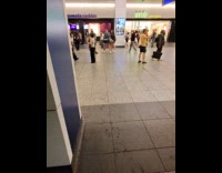 Man plays guitar MTA workers close flooded stairs