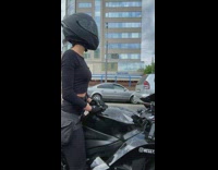 Men Look at Lady on Big Bike