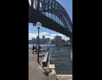 Girl in Turquoise Dress Poses Near Water
