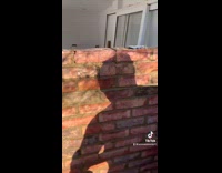 Guy lays bricks while coworker breaks through wall