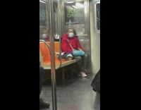 Train passenger balances water bottle on head 