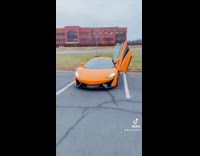 Guy roasts red bmw orange mclaren car 