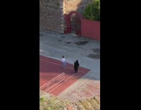 White shirt girl poses red ground neighborhood 