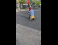 Guy rides on mini car in street