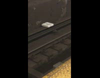 white pizza box on subway rail tracks