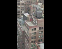 Man white shirt jump rope building rooftop