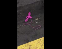 Dropped pink object on train tracks station 
