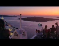 Sunset over ocean crowded rooftop balcony boat