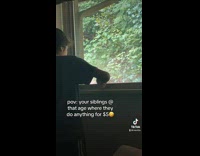 Kid cleans window with a toothbrush 