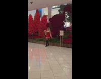 Woman santa dress hold dog large red bear statue