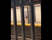 Man blue shirt plays saxophone at platform