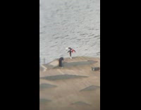 Black shirt two sticks pose cement platform 