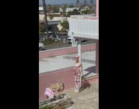 Woman in sexy pink bunny costume at the parking lot