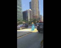 Woman blue dress at road center island sunlight