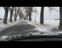 Wind blows snow across street 