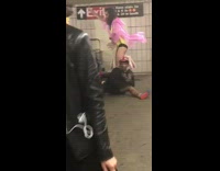 Guy pink shirt yellow body suit on unicorn singing running subway