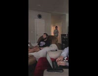 Girl walks into living room and plays christmas music on clarinet 