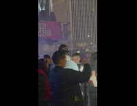 Woman in bikini both hands peace sign at the concert