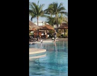Woman takes picture in pool foot splash