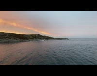 Double rainbow and a sunset opposite to each other at the sea