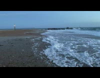 Beach waves forms up bubble foam on the shore