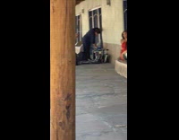 Woman in orange dress poses at the stone bench