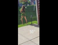 Woman in nature costume poses at the backyard