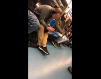 Guy listening to music on subway looks like Toby Flenderson doppleganger from The Office