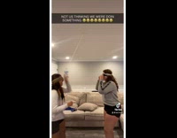 Two girls dodging bottle that fell off string fail